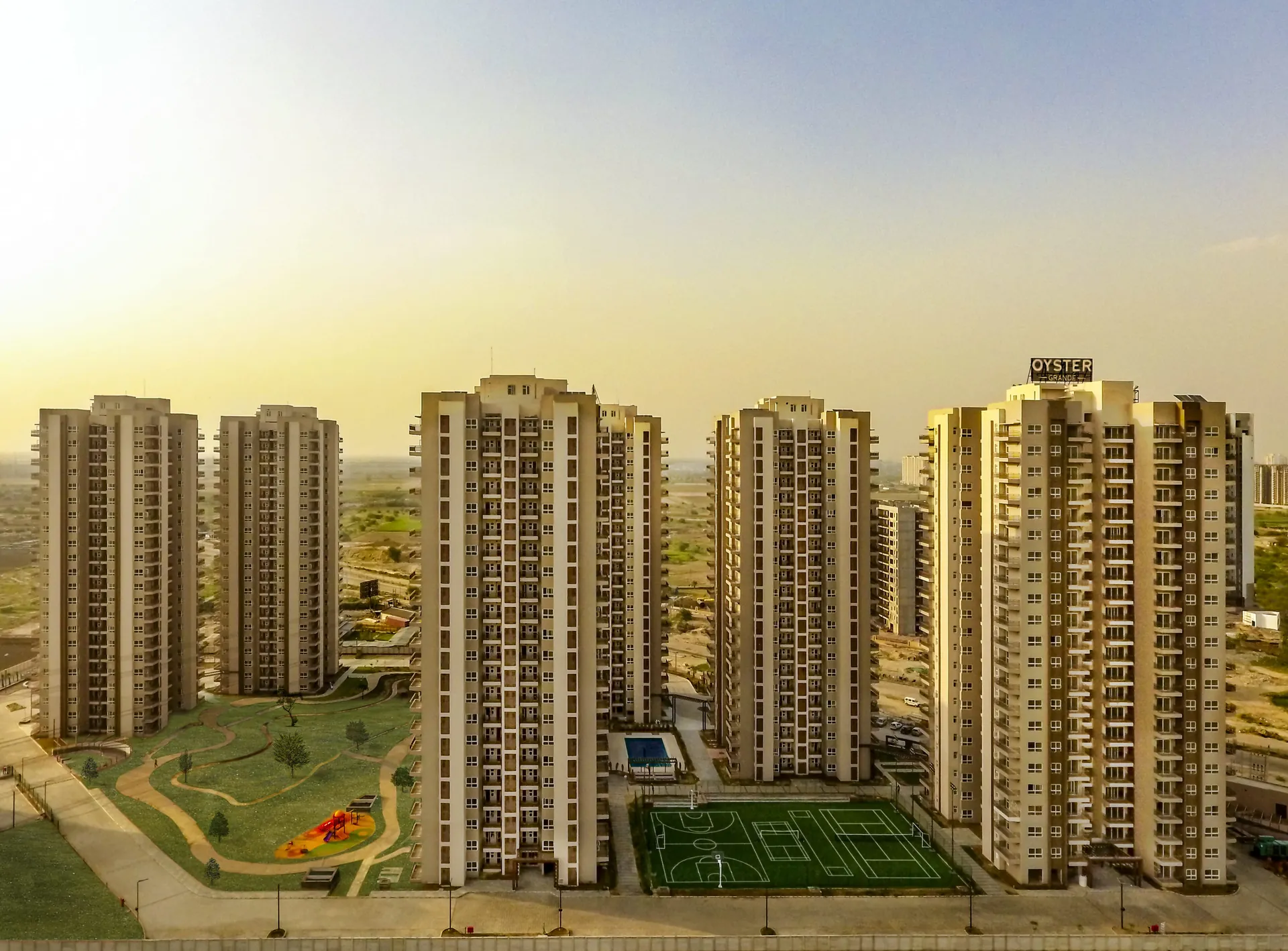 Adani Oyster Grande — aerial view of towers and landscaped grounds (real photo)