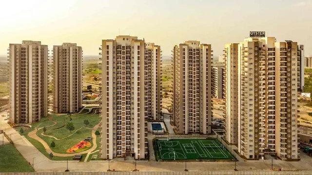 Adani Oyster Grande — aerial of towers with sports courts (real photo)