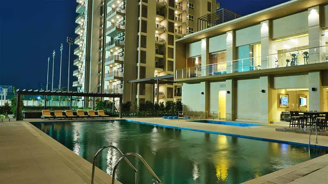 Adani Oyster Grande — pool and clubhouse at dusk (real photo)