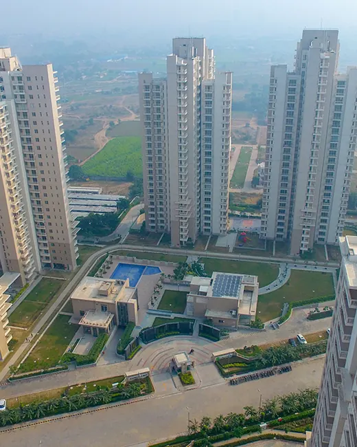 Alpha Gurgaon One — aerial view of towers and clubhouse (real photo)
