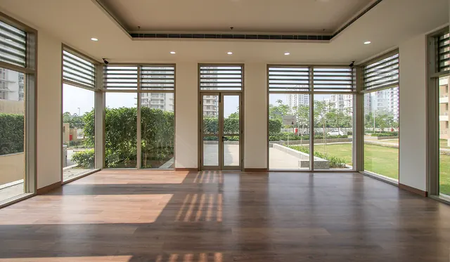 Alpha Gurgaon One — clubhouse hall interior (real photo)
