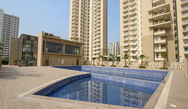 Alpha Gurgaon One — swimming pool and clubhouse (real photo)