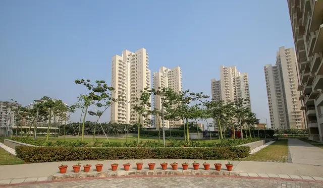 Alpha Gurgaon One — central garden and towers (real photo)