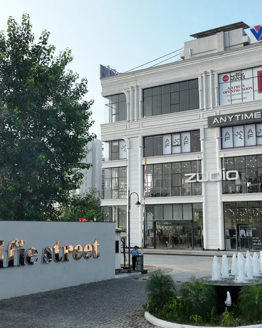 AMB Selfie Street — completed building with entrance signage and fountain (real photo)