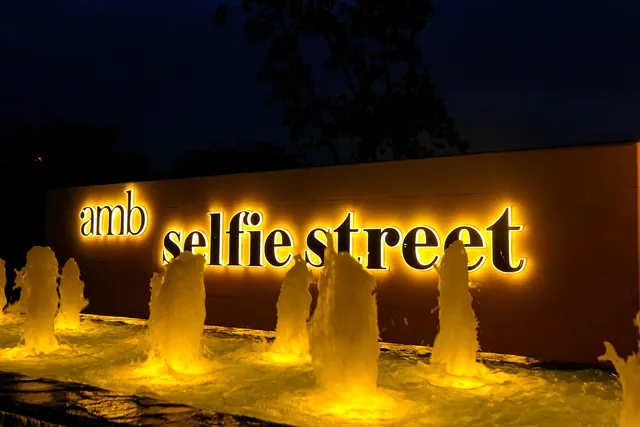 AMB Selfie Street — illuminated entrance sign with fountain