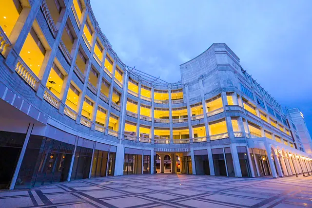 AMB Selfie Street — curved arcade facade at dusk (real photo)