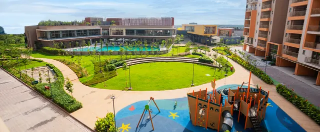 Ashiana Amarah — clubhouse, lawn and play area aerial (real photo)