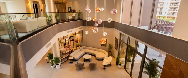 Ashiana Amarah — clubhouse lounge interior (real photo)