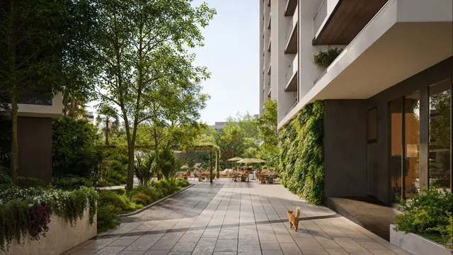 Aura The Aerth — Landscaped walkway beside a tower (render)