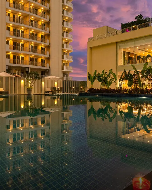 BPTP Terra — towers and clubhouse with pool at dusk (real photo)
