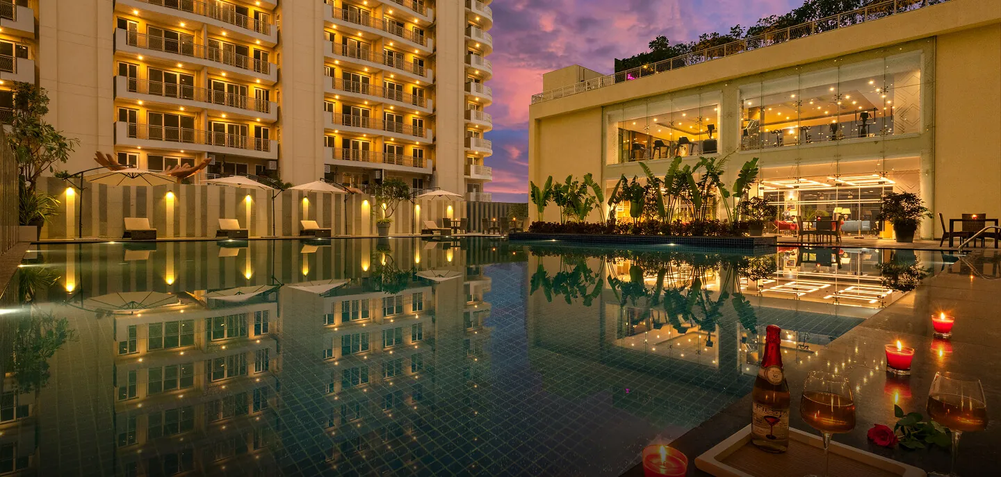 BPTP Terra — towers and clubhouse with pool at dusk (real photo)