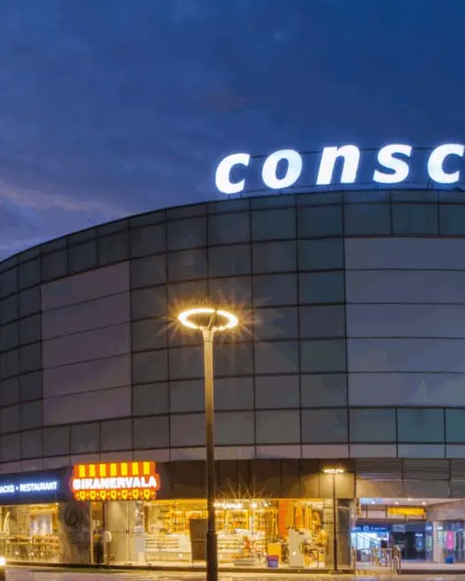 Conscient One Gurgaon — mall facade at dusk with signage