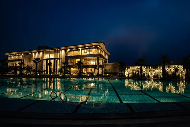 County The Center Court — clubhouse and pool at night (real photo)