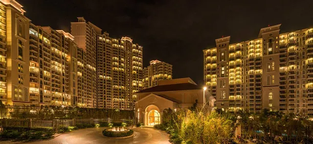 DLF Regal Gardens — towers and clubhouse at night (real photo)