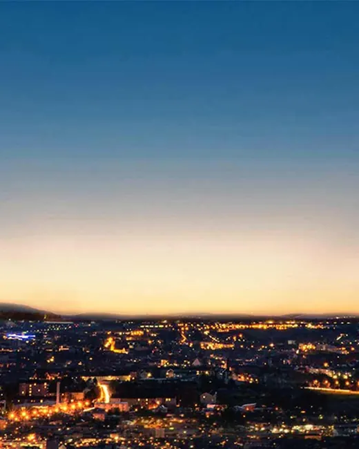 DLF Sky Court — tower at dusk over city skyline (render)