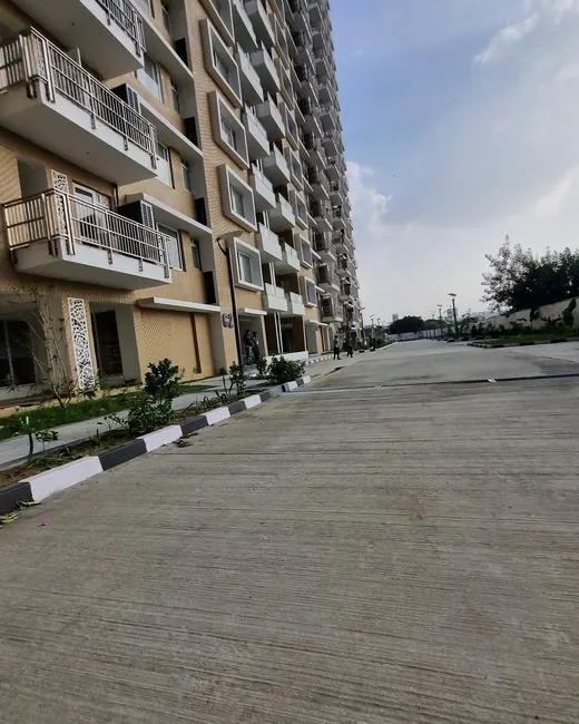 Kashish Manor One — actual photo - tower and internal road (Nov 2025)