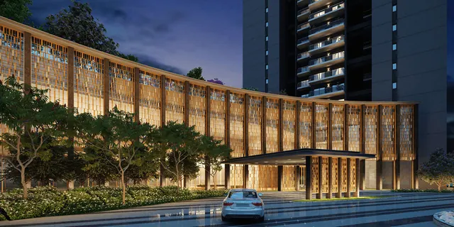 Krisumi Waterfall Residences — clubhouse drop-off and tower at dusk
