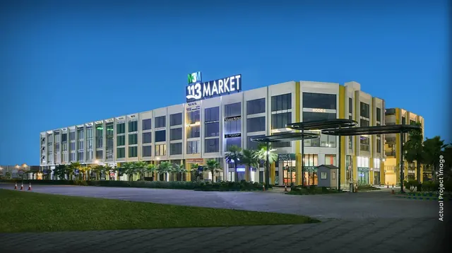 M3M 113 Market — Actual project image at dusk with 113 Market signage