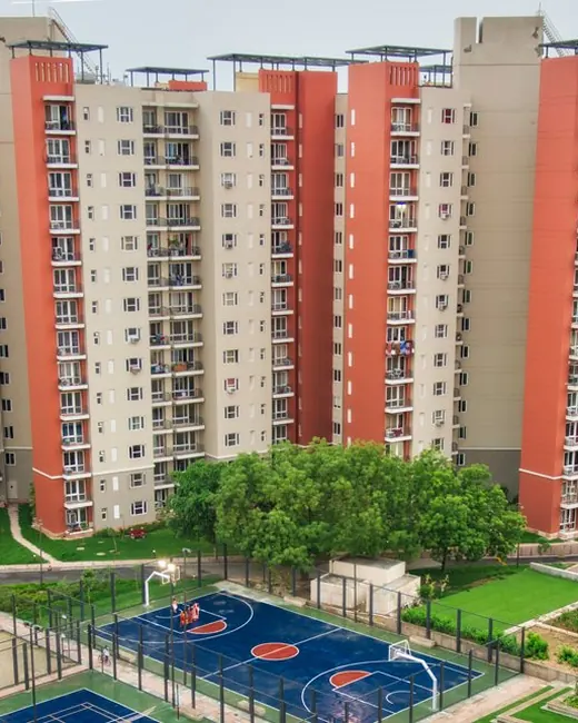 Mahindra Aura — aerial view of towers, courts and pool (real photo)
