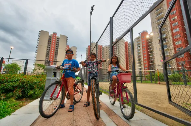 Mahindra Aura — cycling track with kids (real photo)