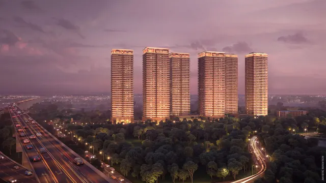 Max Estates 360 — towers lit at night with expressway (render)