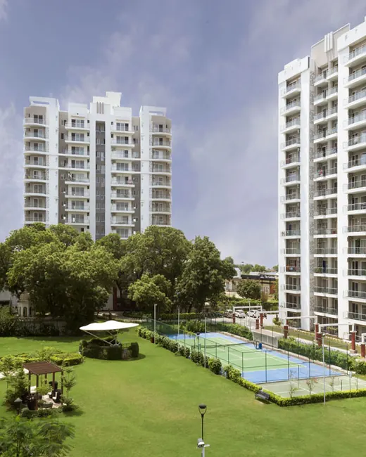 Microtek Greenburg Gurgaon — towers and central lawn with courts (real photo)
