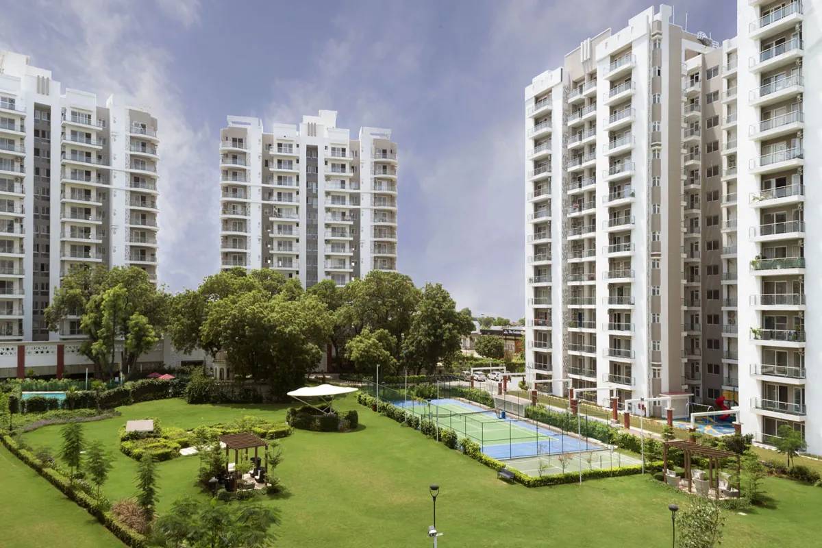 Microtek Greenburg Gurgaon — towers and central lawn with courts (real photo)