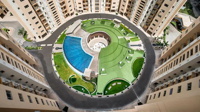 Orris Carnation Residency — top-down view of central pool and lawn (real photo)
