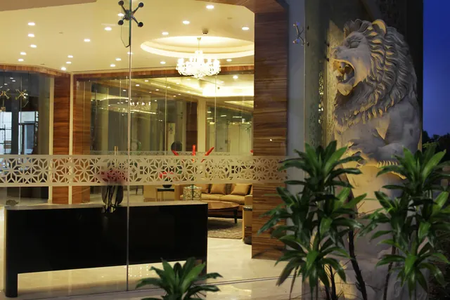 Puri Diplomatic Greens — lobby with lion sculpture (real photo)