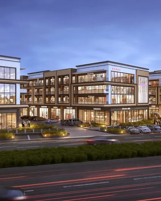 Reach Buzz 114 — Artist's impression: dusk view of SCO frontage along the main road (developer banner, cropped to remove RERA text)