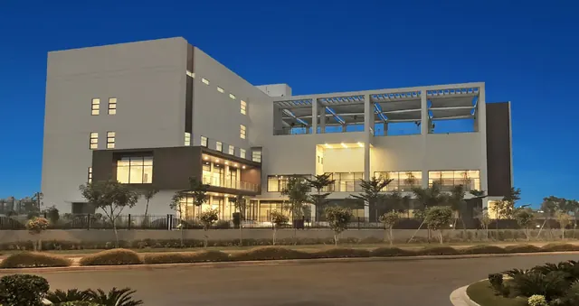Sobha International City — clubhouse exterior at dusk