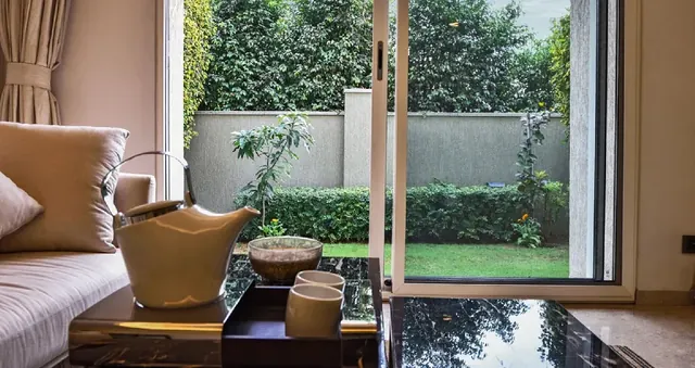 Sobha International City — living room opening to private garden (interior)