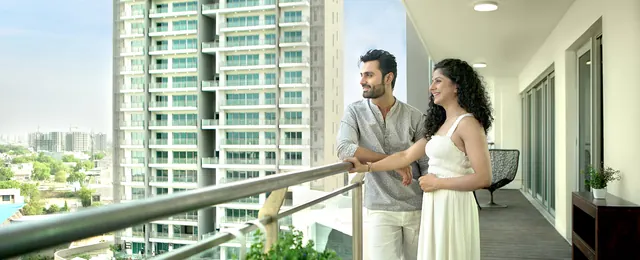 Tata Gurgaon Gateway — banner: couple on balcony with towers (lifestyle, 1920px)